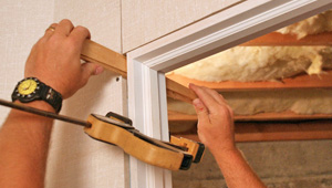 Installing trim and finishing touches to a remodeled basement in [[custom_tbf_major_city_2]]