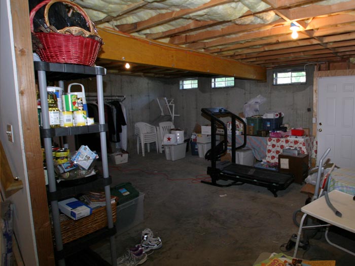 Steps To Take Before Finishing Your Basement An Unfinished Basement Filled With Clutter
